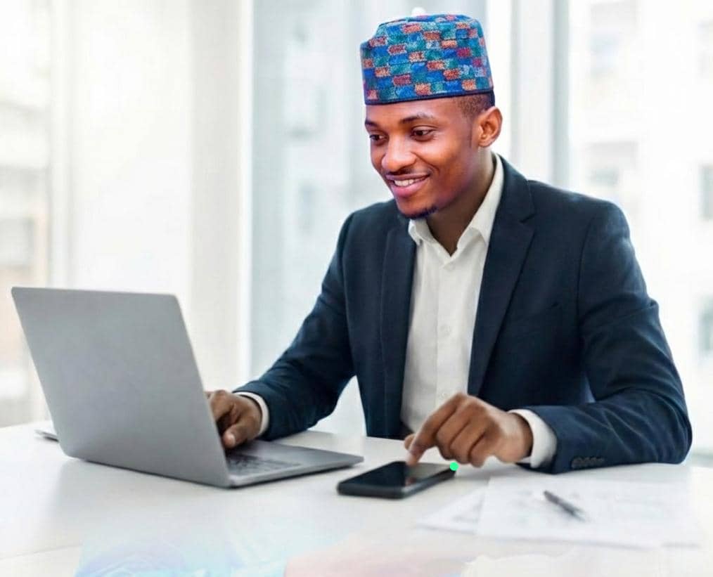 Professional using laptop and phone